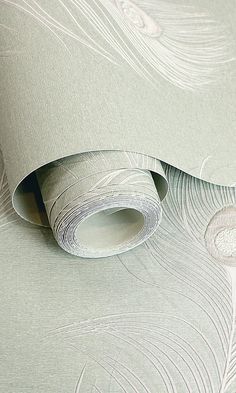 an image of a wallpaper design with white feathers on the background and light green paper