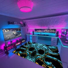 this is a bedroom with purple lighting and gaming equipment