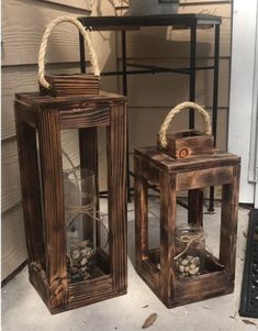 two wooden lanterns sitting on top of a porch