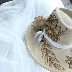 Burned Wide Brim Bridal focused Hat in Antique Beige, but also available in other shades of white. This Hat is burned using pyrography techniques. Embellishments with Rhinestones used for some bling and brightness. Dried Flowers and chiffon ribboning for the band details. Add your Date, initials and anything else youll want on your Forever Hat. Pyrography Techniques, Velvet Hat, October 5, Wedding Hats, Wedding Bar, Shades Of White, Wide Brimmed Hats, Brim Hat, Custom Hats