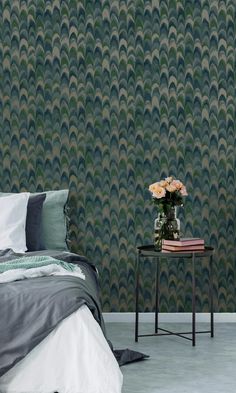 a room with a bed, nightstand and wallpaper that looks like an art deco wave