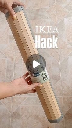 two hands are holding a piece of wood in front of a tile floor with the words ikea hack on it