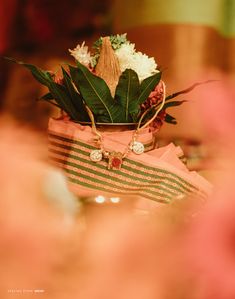 a vase with flowers in it sitting on top of a table next to other items