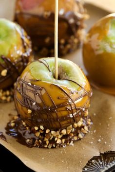 caramel apples with chocolate and sprinkles on a plate, ready to be eaten