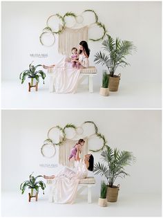 two women sitting on a bench in front of a wall with plants and greenery