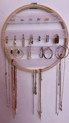 a circular wooden frame with various jewelry hanging on it