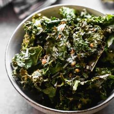 a bowl filled with broccoli on top of a table