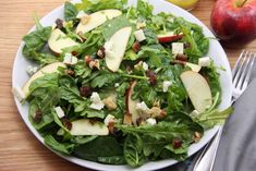 a white plate topped with salad and apples