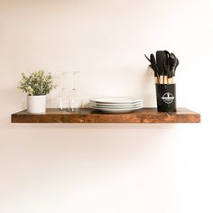 a shelf with utensils and plates on it