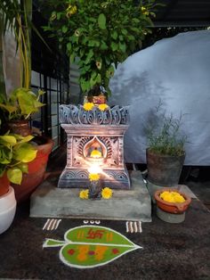 a small shrine with flowers and potted plants