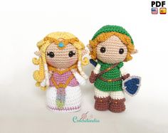 two crocheted figurines are standing next to each other