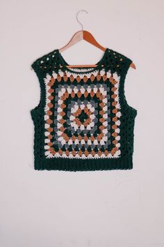 A granny square vest on a hanger. Granny Square Vest Pattern, Easy Crochet Vest, Retro Granny Square, Granny Square Vest, Easy Granny Square, Yarn Project, Make And Do Crew, Granny Square Sweater, Scrap Yarn