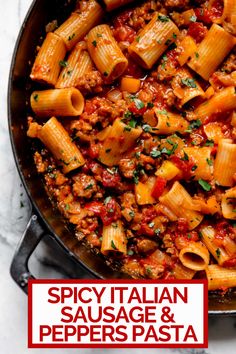 a skillet filled with pasta and sauce on top of a white table next to a red sign that says spicy italian sausage and peppers pasta