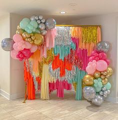 balloons and streamers decorate the entrance to a party