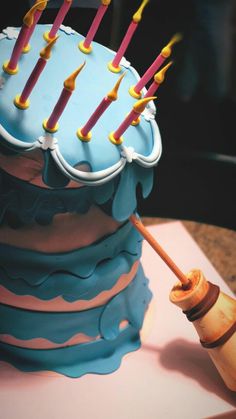 a birthday cake with candles sticking out of it's icing and frosting