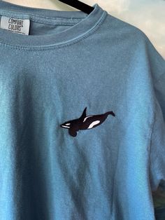 "Original Design Embroidered Orca T-Shirt! Lots of different color choices and sizes, this shirt is designed to be for Unisex but the sizing is in Men's, just check out the size chart and order accordingly! This Embroidered Orca Whale Comfort Colors shirt is part of my \"Ocean Creature Shirts\" collection. OTHER SHIRTS YOU MIGHT LIKE: LOOKING FOR THE SWEATSHIRT VERSION? https://www.etsy.com/listing/1601795282/orca-whale-embroidered-gildan-sweatshirt Interested in Embroidered Mom and Baby Orca shirt? See my other listing here: https://www.etsy.com/listing/1516341946/orca-whale-embroidered-bella-canvas Embroidered Orca Whales Mom of Two Comfort Colors Shirt: https://www.etsy.com/listing/1586621759/mom-of-two-embroidered-orca-shirt-orca If you're looking for a thick, structured tee that's als Whale Tee Shirt, Casual Embroidered Crew T-shirt, Casual Long Sleeve Shirt With Custom Embroidery, Blue Crew T-shirt With Embroidered Graphics, Blue Embroidered Crew T-shirt, Casual Crew Neck T-shirt With Custom Embroidery, Casual Blue Top With Embroidered Text, Blue Crew T-shirt With Custom Embroidery, Blue Crew Neck T-shirt With Custom Embroidery