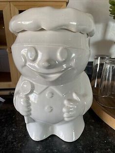 a large white ceramic vase sitting on top of a counter