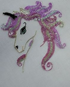 a close up of a horse made out of beads