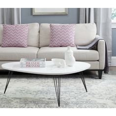 a white coffee table sitting in front of a couch