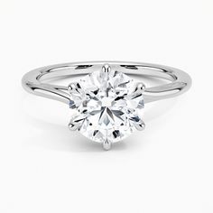 a round brilliant cut diamond engagement ring on a white background with the center stone visible