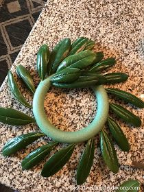 a green ring sitting on top of a granite counter next to a knife and fork