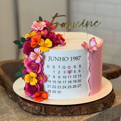 a birthday cake decorated with flowers and a calendar