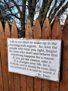 a wooden fence with a sign that says life is too short to wake up in the morning