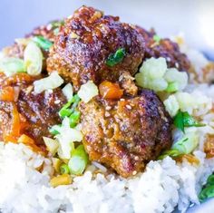 meatballs and vegetables are on top of white rice