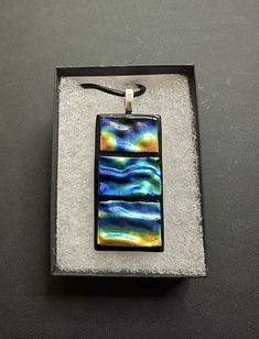 This stunning dichroic glass necklace is handmade by yours truly here in Eau Claire, Wisconsin. This beautiful one-of-a-kind piece measures 2" in height, and 1" in width. Each piece is topped with a sterling silver plated bail and comes with a 20" black leather cord upon purchase. Eau Claire Wisconsin, Dichroic Glass, Yours Truly, Glass Necklace, Necklace Handmade, Leather Cord, Handmade Necklaces, Jewelry Inspiration, Wisconsin