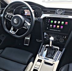 the interior of a car with black leather seats and steering wheel, including an electronic display