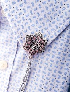 Imagine a touch of ethereal elegance adorning your attire, transforming everyday garments into captivating expressions of your unique style. Our Exquisite Filigree Flower Collar Pin is your gateway to that effortless sophistication. Handcrafted with intricate metalwork, the delicate flower motif blossoms on your lapel, exuding a timeless charm that transcends trends. Whether gracing a crisp shirt collar, adding a touch of whimsy to a dress, or lending polished flair to a jacket, this Filigree Fl Luxury Casual Shirt With Lapel Collar, Collar Pins Necklaces, Luxury Lapel Pin Brooch For Business, Collar Pins Watches, Luxury Formal Shirt With Embellished Collar, Luxury Shirt With Lapel Collar For Office, Chain Shirt, Shirt Clips, Flower Collar