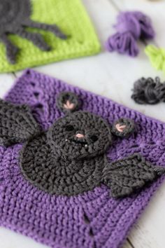 two crocheted bats are sitting on the table