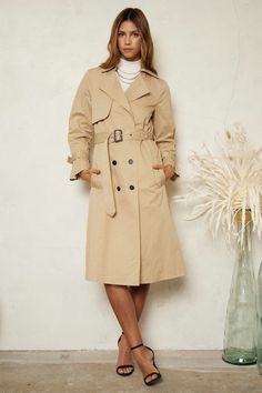 Description This Classic Trench Coat will never go out of style and instantly adds chic to any outfit. So many classic details make this an absolute must have addition to your capsule. It features double-breast styling, wide lapel, a collared neck and is self-belted. All About the Fit Fabric Feel (light) 1 2 3 4 (heavy) Fit (slimfit) 1 2 3 4 (loosefit) Fabric Details: 100% Cotton Chic Outerwear For Work, Chic Fitted Outerwear With Belted Cuffs, Fitted Double-breasted Collared Outerwear, Fitted Collared Double-breasted Outerwear, Fitted Double-breasted Spring Outerwear, Chic Solid Collared Outerwear, Chic Solid Color Collared Outerwear, Chic Collared Office Outerwear, Chic Office Outerwear With Lapel Collar