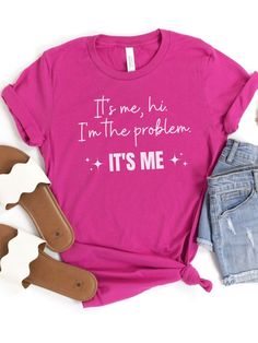 Introducing our "It's Me, Hi. I'm the Problem. It's Me" T-Shirt, a fun and playful shirt inspired by a popular song lyrics. Made from high-quality Bella + Canvas brand t-shirt, this shirt is both comfortable and durable. The design features the words "It's Me, Hi. I'm the Problem. It's Me" in a bold font, making it a great statement piece that will spark some conversations. Available in eight colors, including classic black and a variety of bright and bold hues, there's a shade for every style. Popular Song Lyrics, Branded T Shirts, Jersey Shorts, Women Collection, Statement Pieces, Song Lyrics, Fabric Care, Classic Black, Bella Canvas