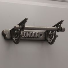 the london sign is attached to an old metal door knocker that says london on it