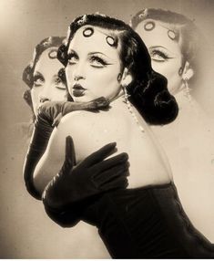 three women wearing gloves and makeup are posing for the camera