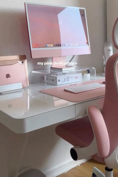 an apple desktop computer sitting on top of a white desk next to a pink chair