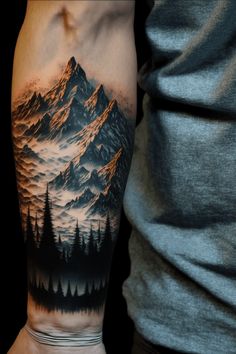 a man's arm with a mountain and trees tattoo on the upper half of his arm