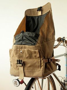 the back end of a bicycle with a bag on it