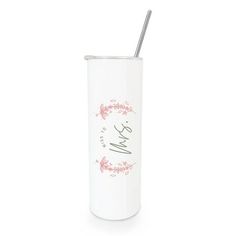 a white and pink tumbler with a straw sticking out of it's side