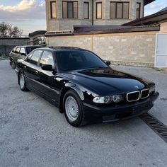 a black car parked in front of a building