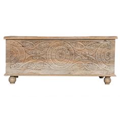 an old wooden box with carvings on the front and sides, isolated against a white background