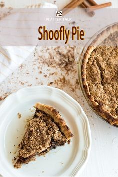 a piece of pie sitting on top of a white plate next to a glass dish