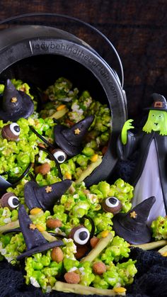 a bowl filled with broccoli covered in halloween decorations