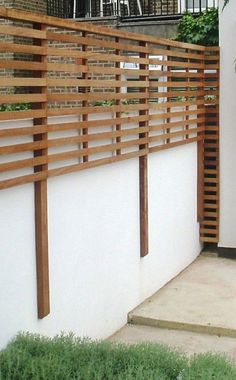 a white wall with wooden slats on it