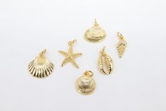 Gold Seashell Charms **SPECIFICATIONS** Measurements Approximately: #1 Starfish - 15 x 16 mm #2 Small Scallop - 13 x 14 mm #3 Round Shell - 11 x 13 mm #4 Mini Spiral Shell - 6 x 15 mm #5 Large Scallop - 14 x 16 mm #6 Mini Cowrie - 9 x 15 mm Holes: N/A Plated Colors: Gold Stones: N/A Quantity of Items: 1 piece unless otherwise selected Materials: Copper Base Conversion in MM: US Dime 18 mm; US Nickel is 21.5 mm; US Quarter is 24 mm; Conversion: 1 inch = 25.4 mm We welcome all custom orders or who Spiral Shell, Cz Jewelry, Shell Beads, Focal Bead, Leather Items, Starfish, Handcrafted Jewelry, Sea Shells, Natural Gemstones