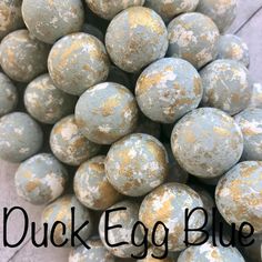 a pile of gray and white eggs with the words duck egg blue on it's side