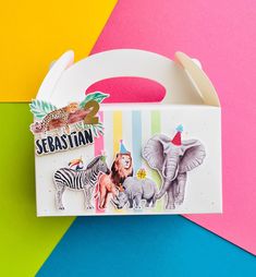 an elephant, zebra, and giraffe sticker on a colorful paper background