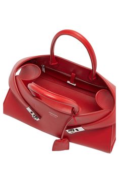 Extended tabs secured with Gancio flip-locks appear to embrace this retro-inspired satchel crafted of calfskin leather in an accordioned structured silhouette. Bridge-toggle closure Top carry handles; removable, adjustable shoulder strap Removable key ring Interior zip pocket Structured silhouette with flat base and protective metal feet Leather Made in Italy Designer Handbags Red Top Handle Satchel With Leather Handles, Red Top Handle Bag With Handles, Red Top Handle Bag With Hasp Closure, Red Top Handle Bag With Lock, Modern Red Top Handle Satchel, Everyday Luxuries, Top Handle, Leather Satchel, Leather Top