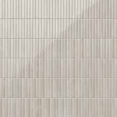 a white tiled wall with vertical lines on it